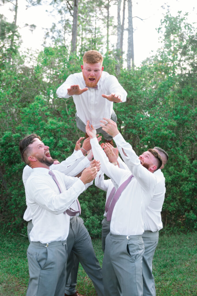 Wedding Photography Tips - groom being thrown in the air