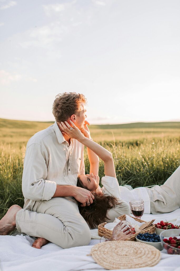 Newly engaged Florida couple having a picnic at sunset