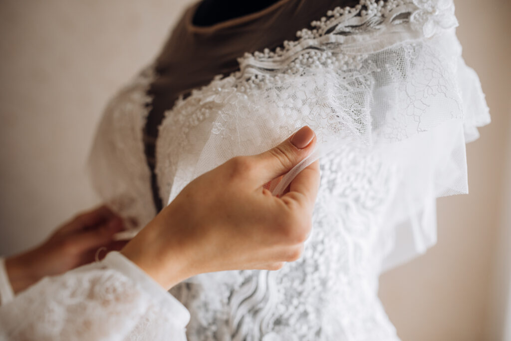 Bride adjusts her bridal dress