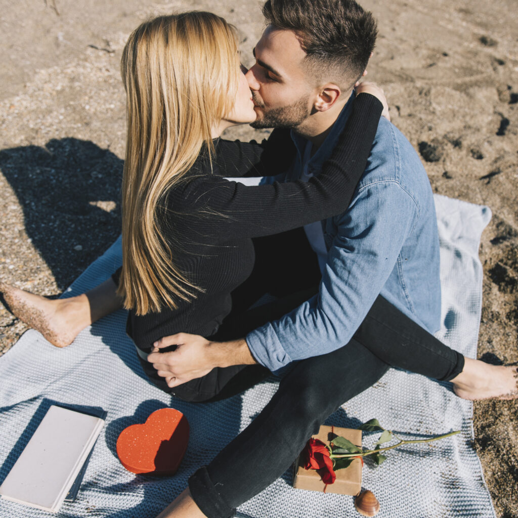 couple on the beach sharing a kiss for engagement session