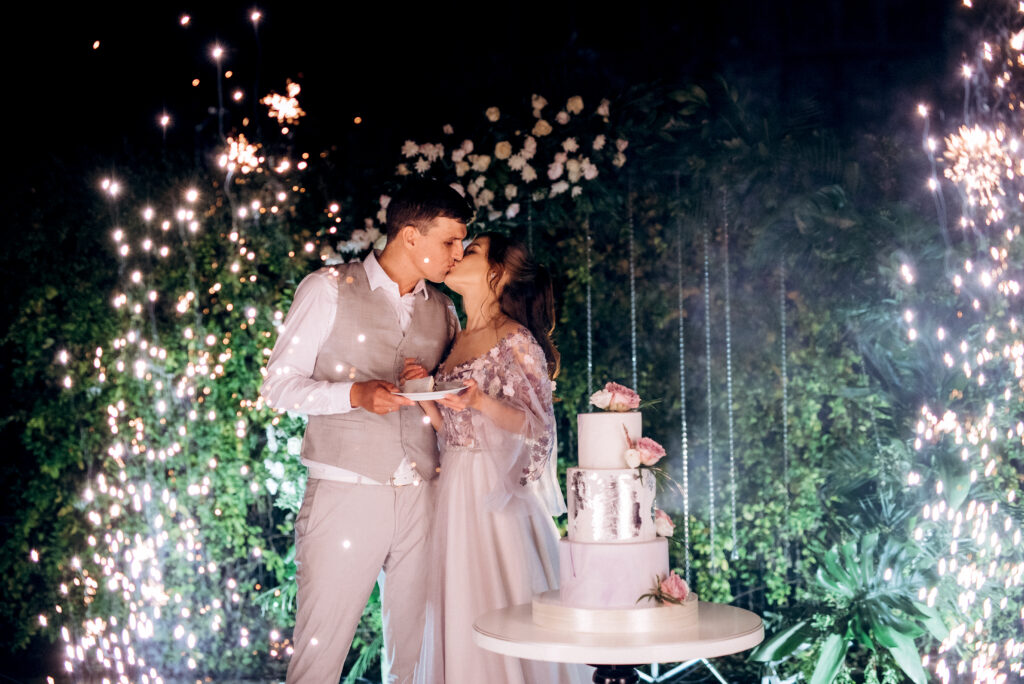 newlyweds happily cut, laugh and taste the wedding cake