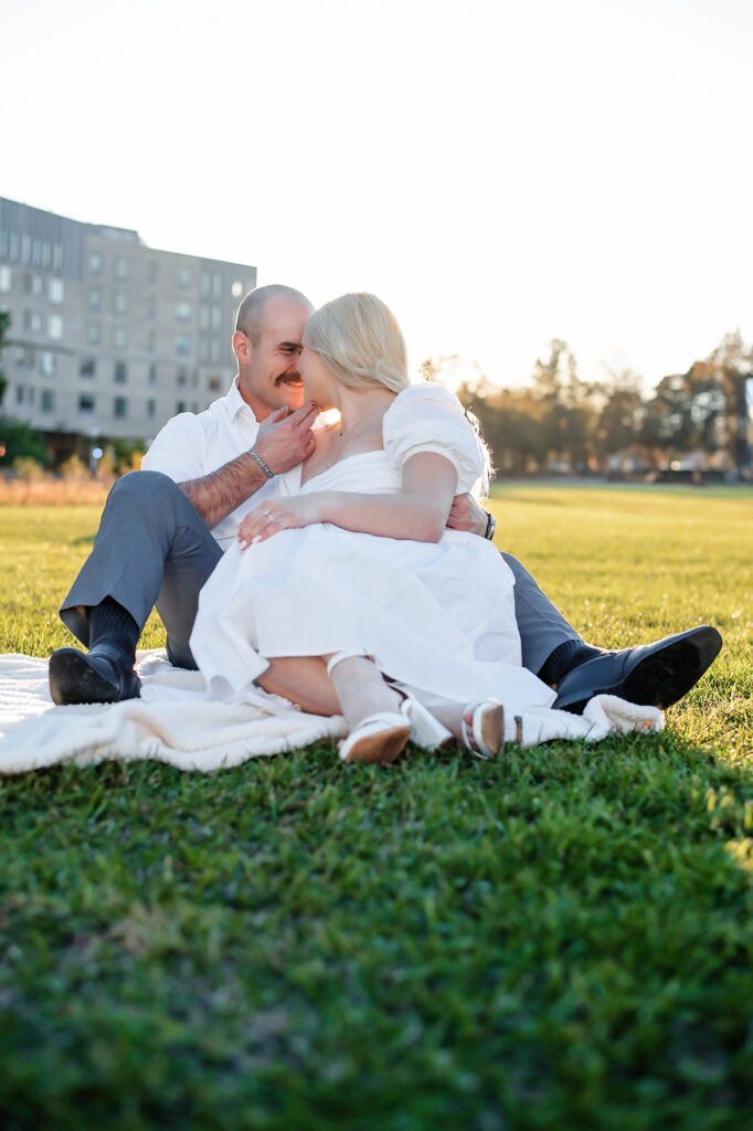 couple sitting on the ground on blanket