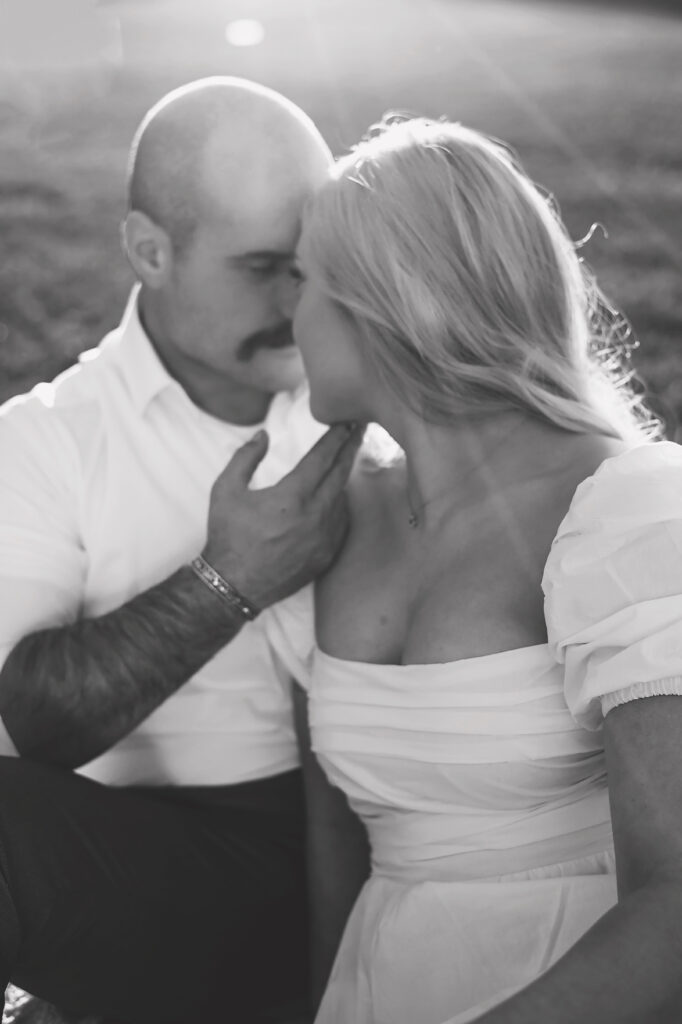 black and white up close of couple sitting on blanket