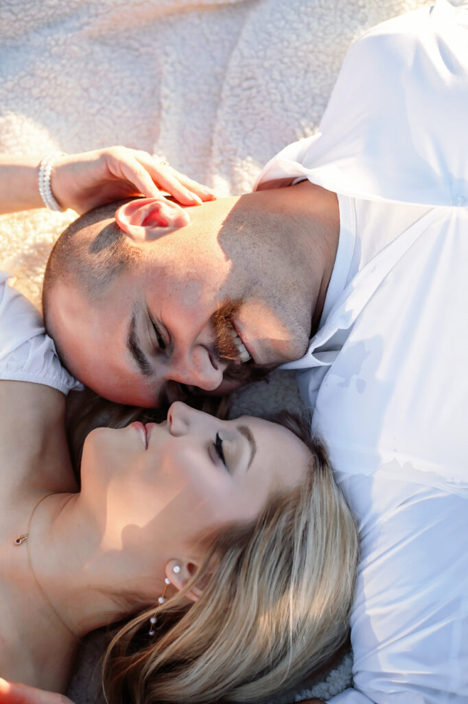 couple laying down facing each other