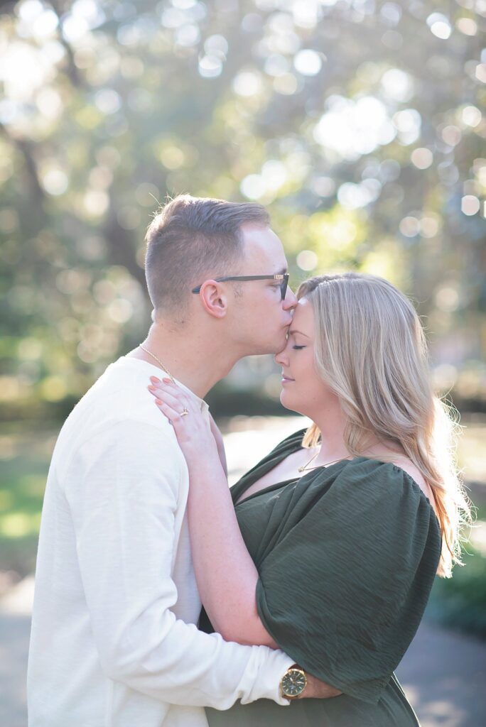 guy kissing fiance's forehead at their savannah georgia engagement photos