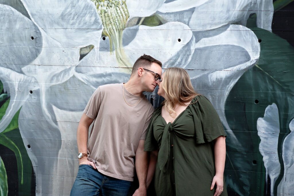 couple holding hands and kissing at their savannah georgia engagement photos