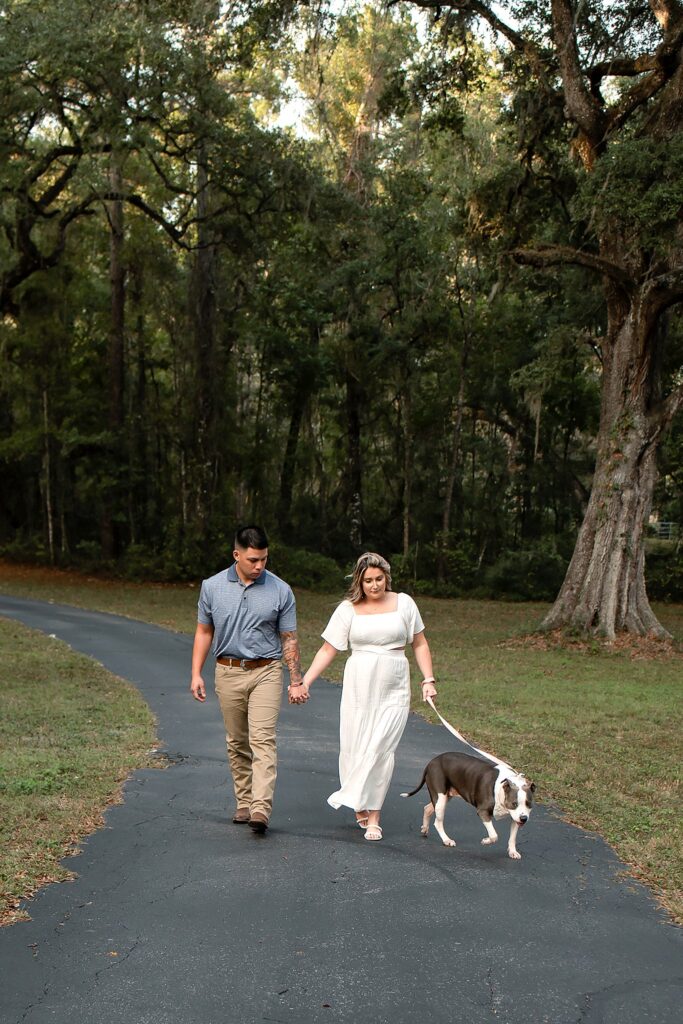 langan acres couple walking holding hands with dog